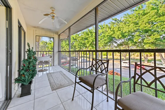 a view of a chairs and table in patio with potted plants