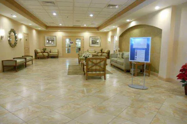 a lobby with furniture and lots of mirrors