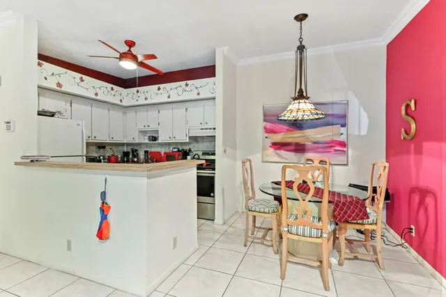 a kitchen with granite countertop a white refrigerator and cabinets