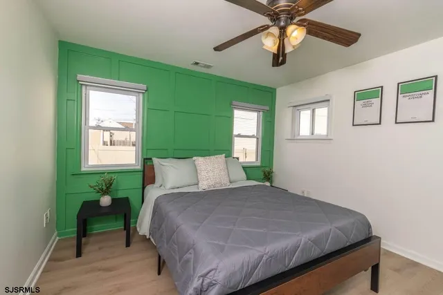 a bed sitting in a bedroom next to a window