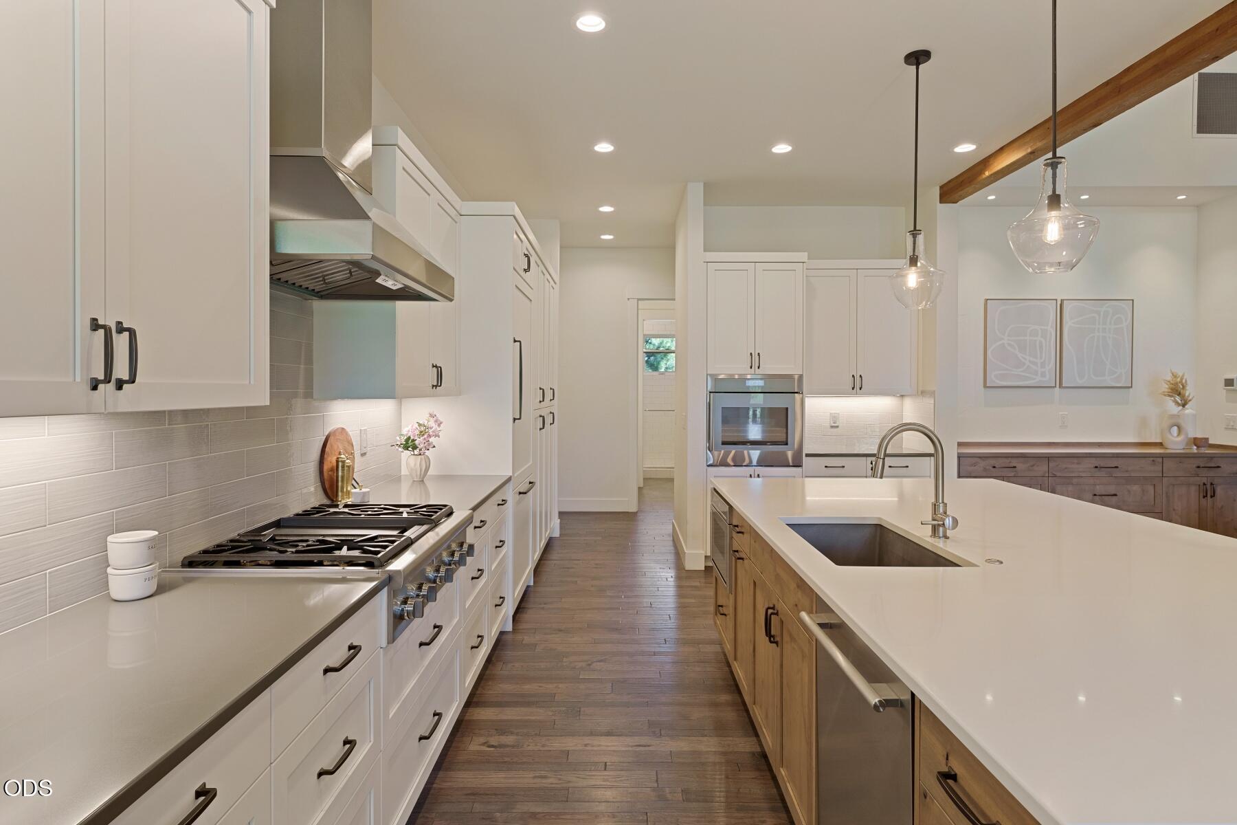 60255 Sunset View Drive Bend, OR 97702 - Photo 13 of 48 a kitchen with kitchen island stainless steel appliances a sink a stove top oven a counter space and cabinets