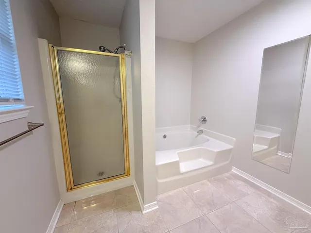 a bathroom with a tub and shower