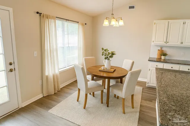 a dining room with furniture and window