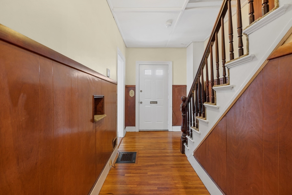 20 Trinity Avenue Lynn, MA 01902 - Photo 14 of 29 a view of a hallway with wooden floor and staircase