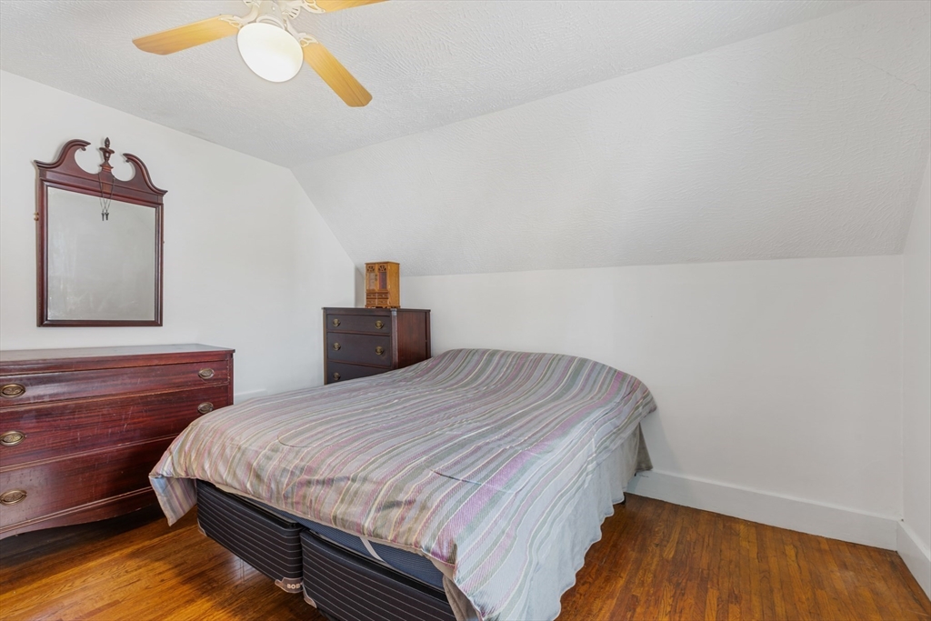 20 Trinity Avenue Lynn, MA 01902 - Photo 17 of 29 a bedroom with a bed and wooden floor