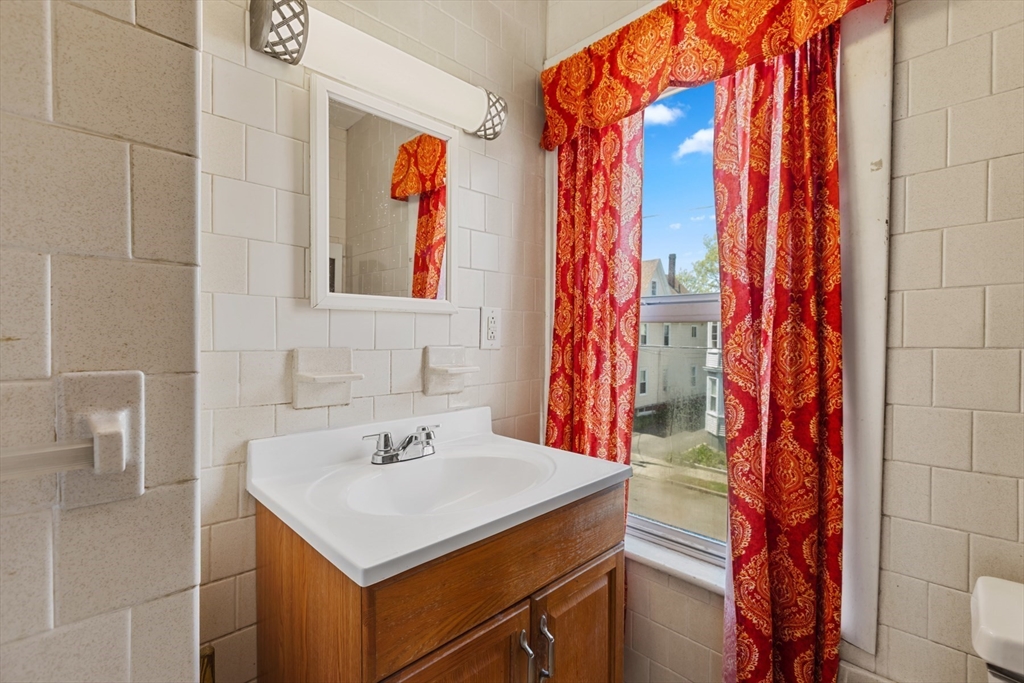 20 Trinity Avenue Lynn, MA 01902 - Photo 24 of 29 a bathroom with a sink and a mirror