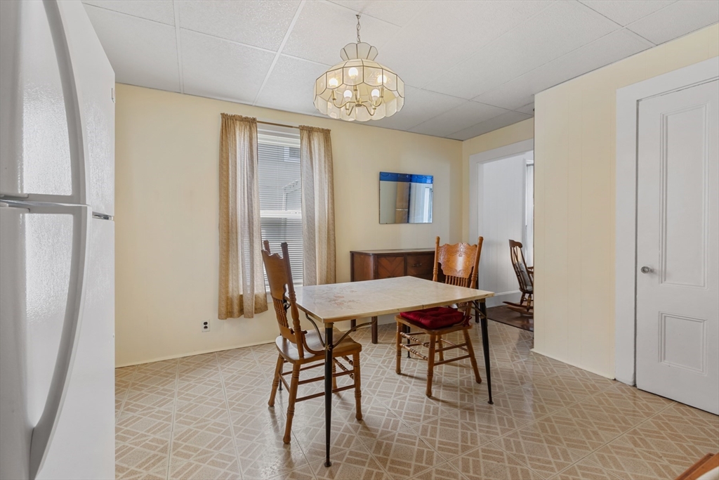 20 Trinity Avenue Lynn, MA 01902 - Photo 7 of 29 a view of a dining room with furniture and chandelier