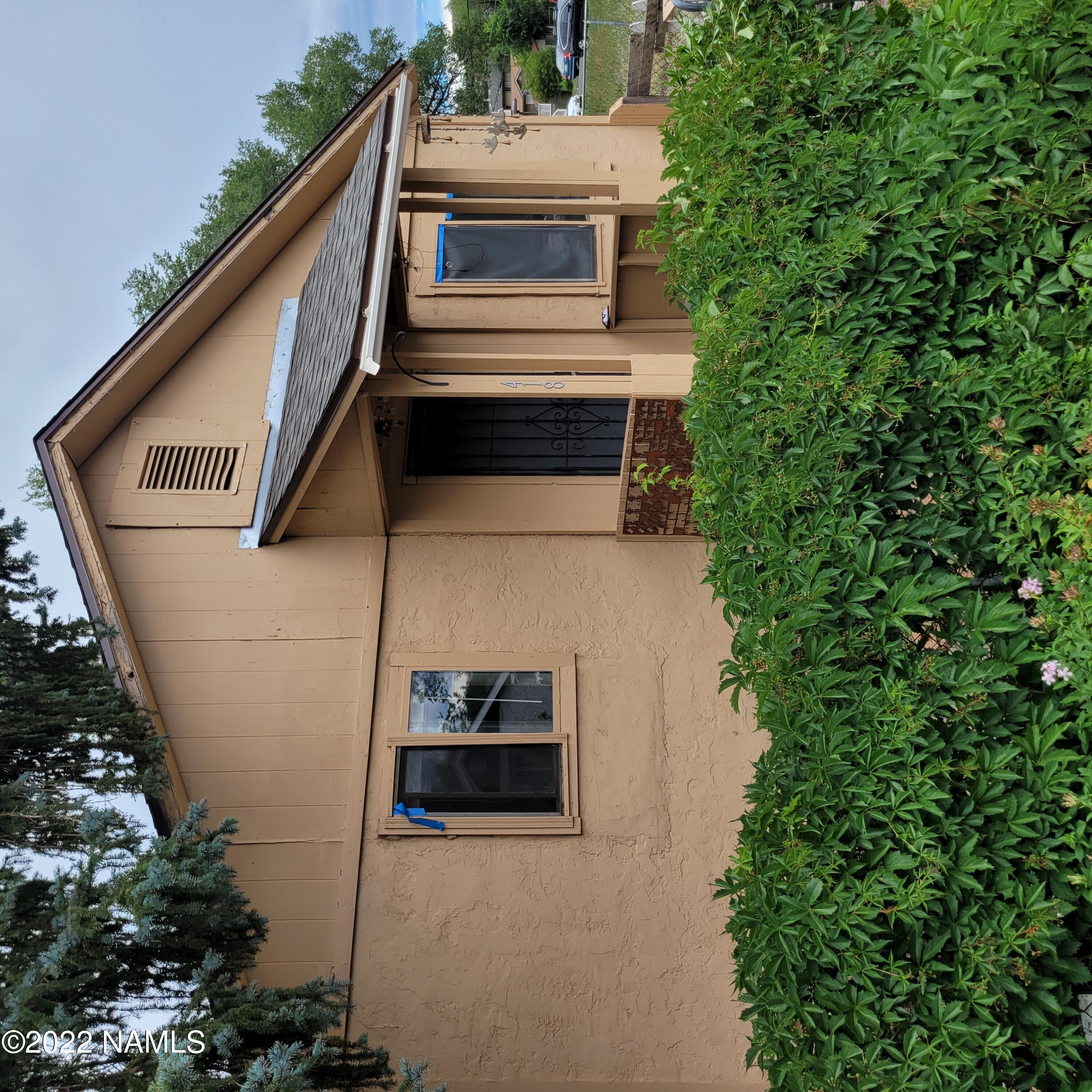 418 South WC Riles Drive Flagstaff, AZ 86001 - Photo 1 of 11 a view of a white house next to a yard