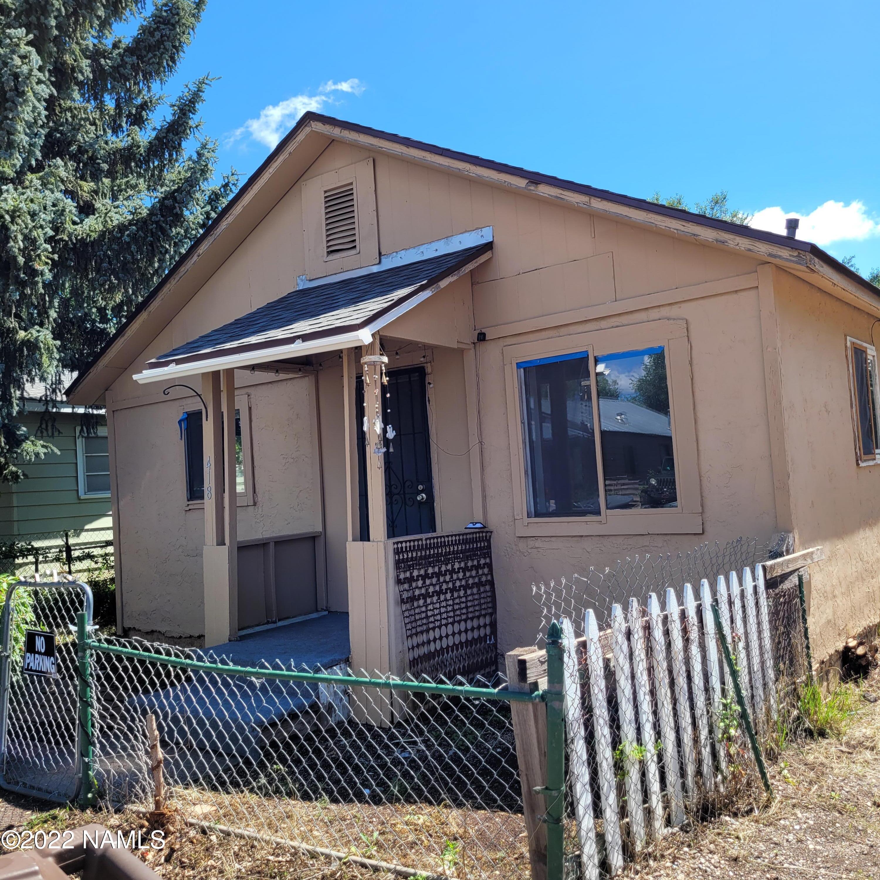 418 South WC Riles Drive Flagstaff, AZ 86001 - Photo 2 of 11 a front view of a house with a fence