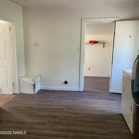 a view of a room with wooden floor and lounge chair