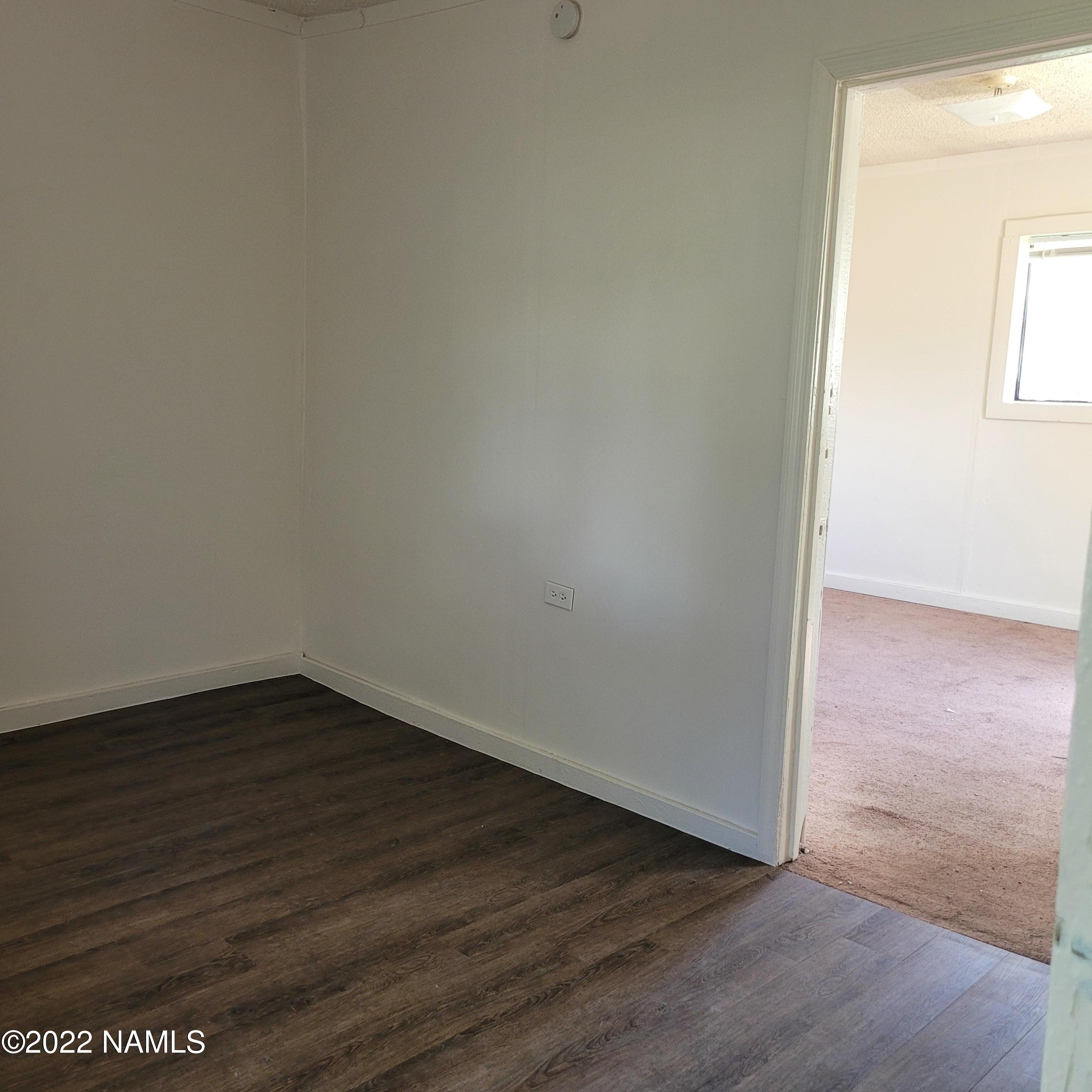 418 South WC Riles Drive Flagstaff, AZ 86001 - Photo 5 of 11 a view of an empty room with wooden floor and a window