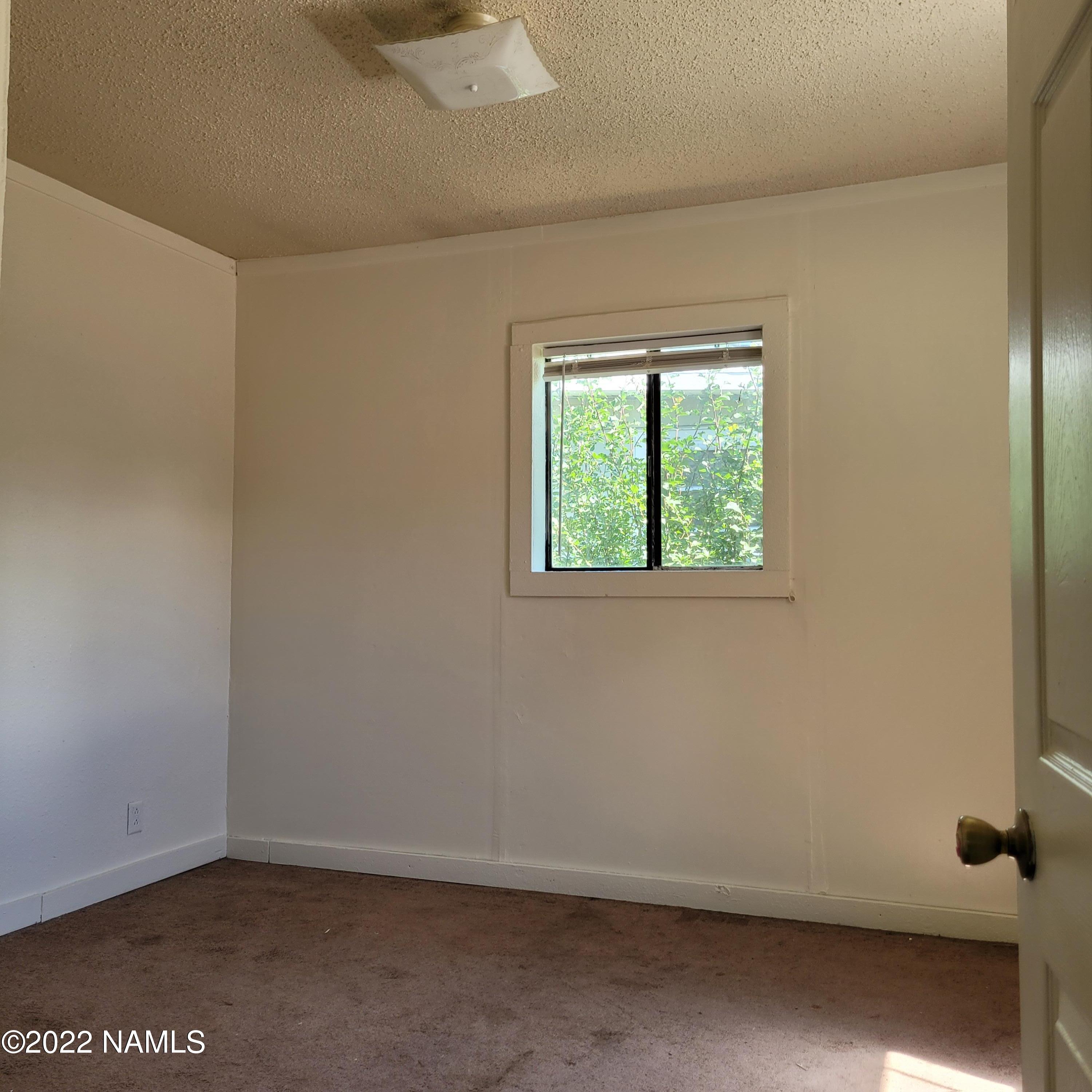 418 South WC Riles Drive Flagstaff, AZ 86001 - Photo 6 of 11 an empty room with a window
