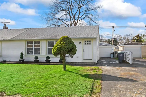 a front view of the house with a yard and garage