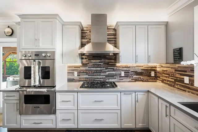 a bathroom with a granite countertop sink mirror vanity and bathtub