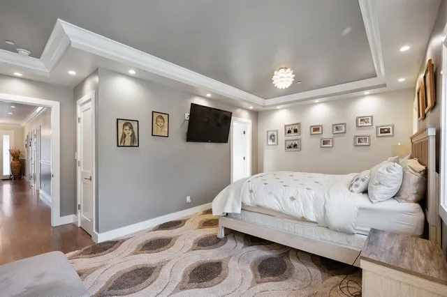 a en suite bathroom with a granite countertop sink and a mirror