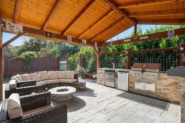 a kitchen with a refrigerator and a stove top oven