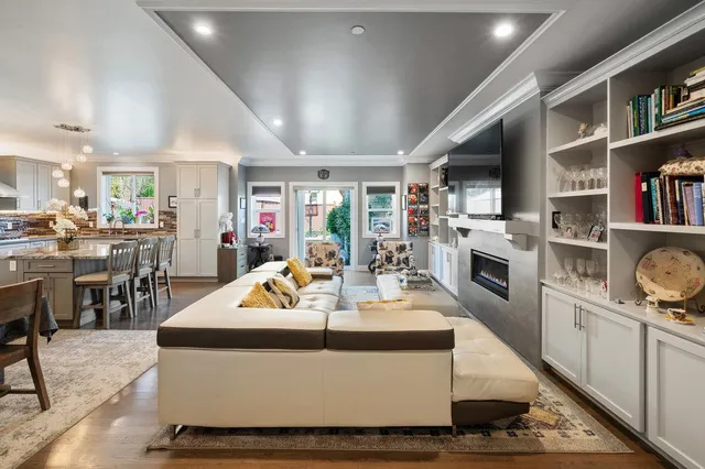 a living room with fireplace furniture and a book shelf