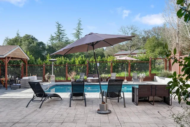 a view of a swimming pool with sitting area