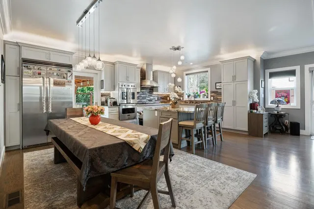 a kitchen with granite countertop a sink stainless steel appliances and cabinets
