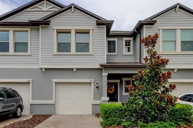a front view of a house with trees