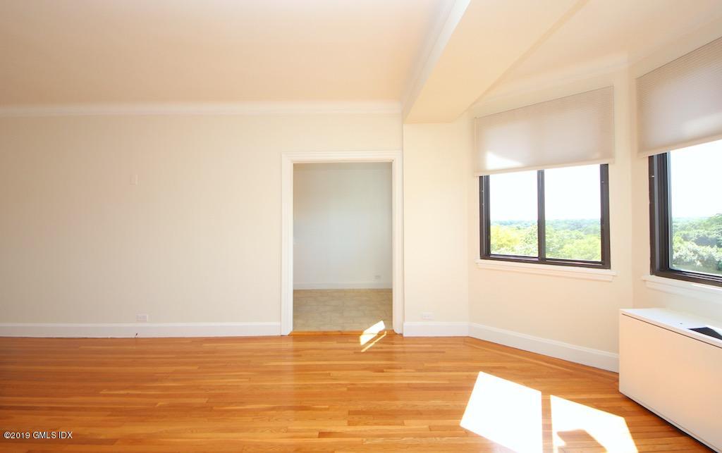 47 Lafayette Place, Unit 5D Greenwich, CT 06830 - Photo 4 of 8 a view of an empty room with wooden floor and a window