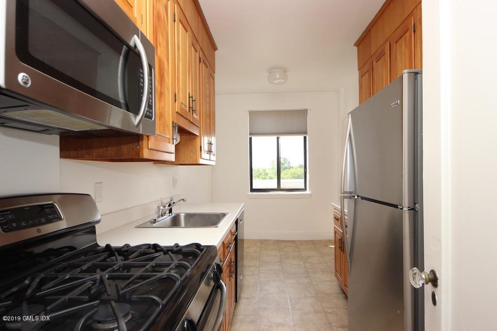 47 Lafayette Place, Unit 5D Greenwich, CT 06830 - Photo 5 of 8 a kitchen with a stove and a microwave