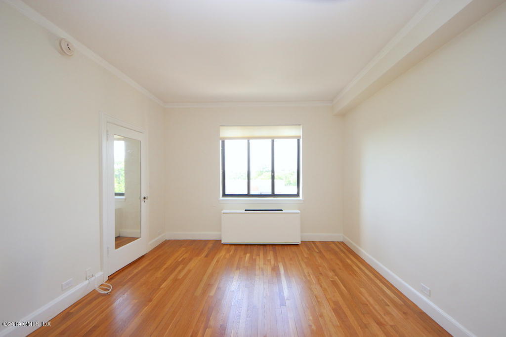 47 Lafayette Place, Unit 5D Greenwich, CT 06830 - Photo 6 of 8 an empty room with wooden floor and windows