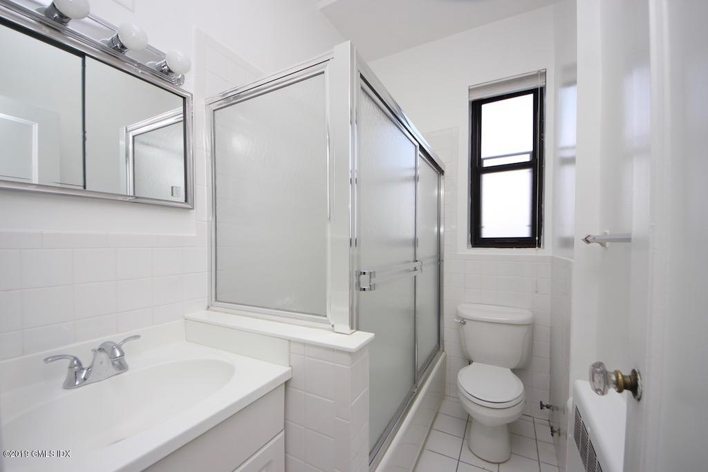 47 Lafayette Place, Unit 5D Greenwich, CT 06830 - Photo 7 of 8 a bathroom with a sink a toilet and shower