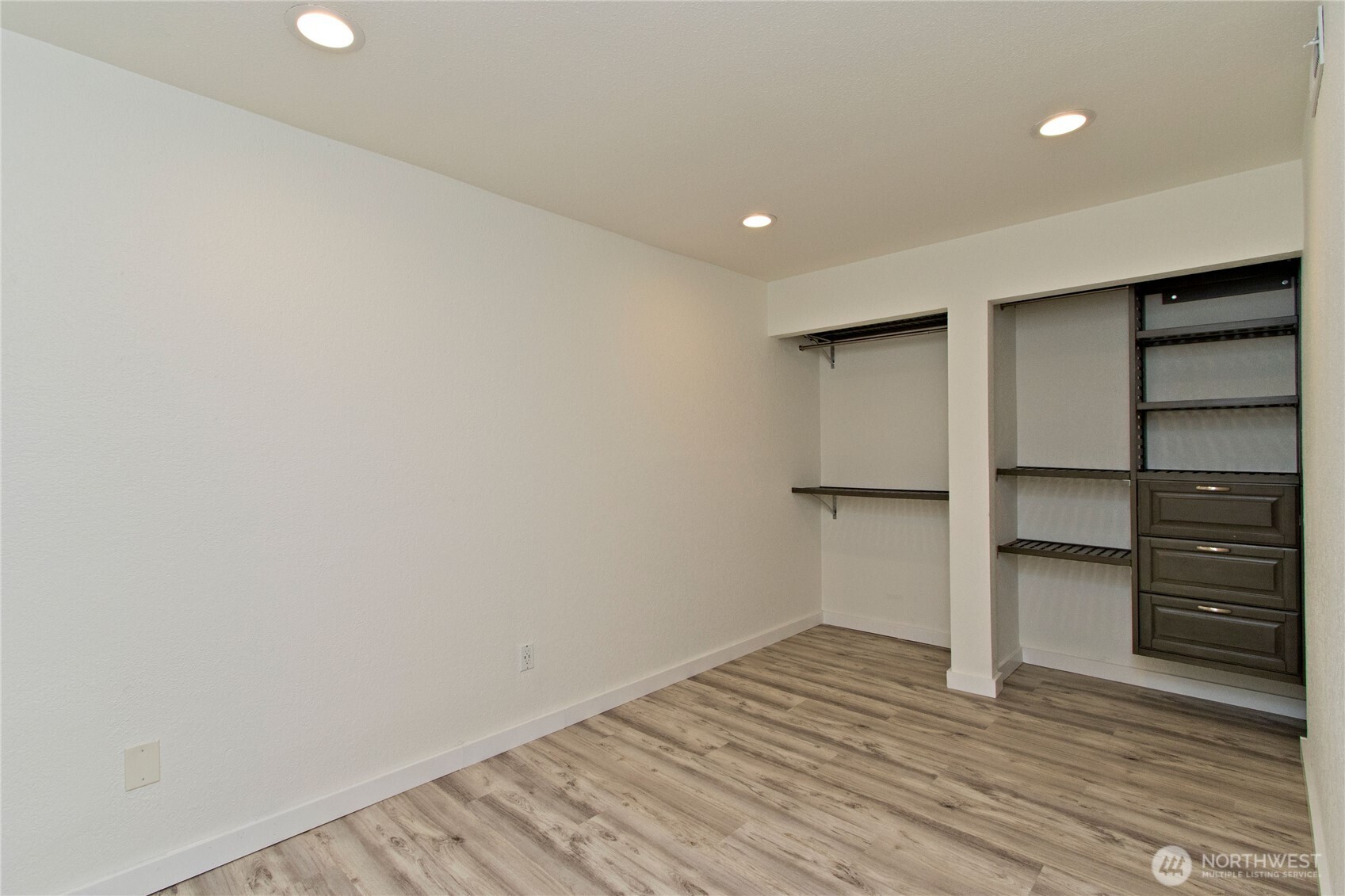 12515 Northeast 145th Place, Unit D127 Kirkland, WA 98034 - Photo 15 of 21 a view of walk in closet with empty racks