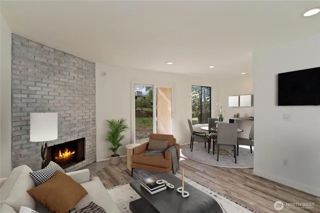 a living room with furniture a fireplace and a flat screen tv