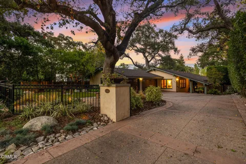 a front view of a house with a lake view