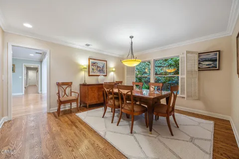 a living room with stainless steel appliances kitchen island granite countertop wooden floor view and a window