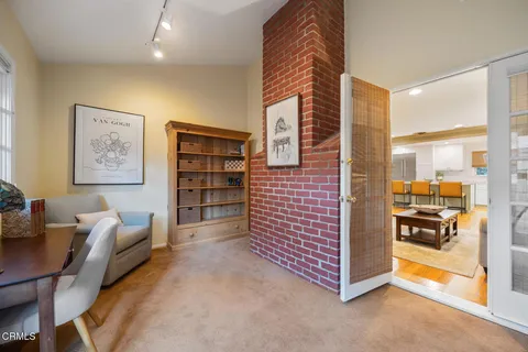 a dining room with wooden floor a chandelier a wooden table and chairs