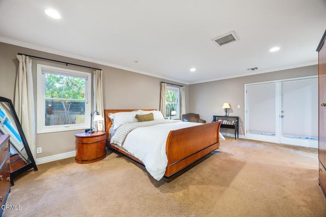 a bed room with a bed and a large mirror