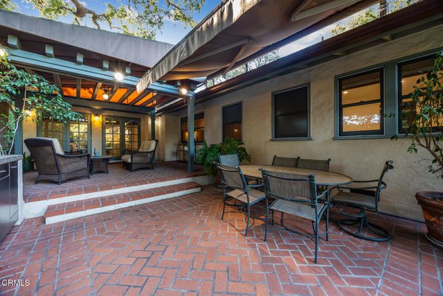 a view of a house with a yard porch and sitting area