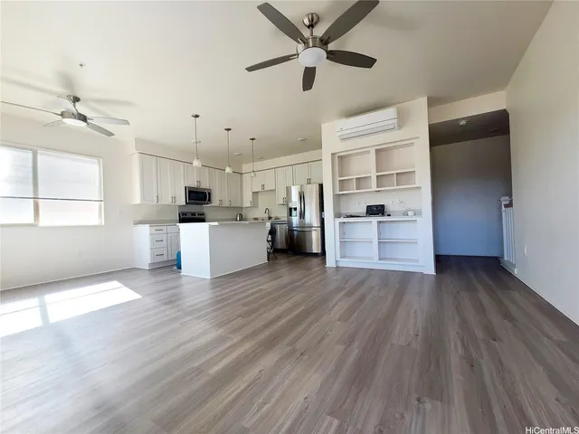 a view of a kitchen with wooden floor and a ceiling fan