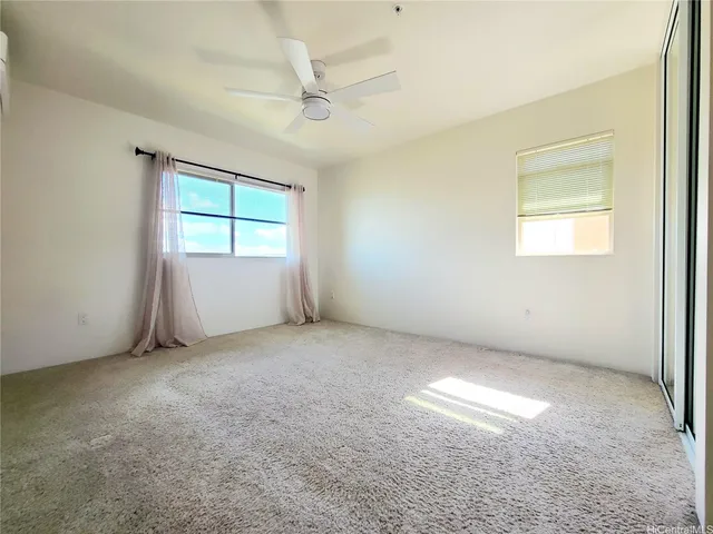 en empty room with windows and fan