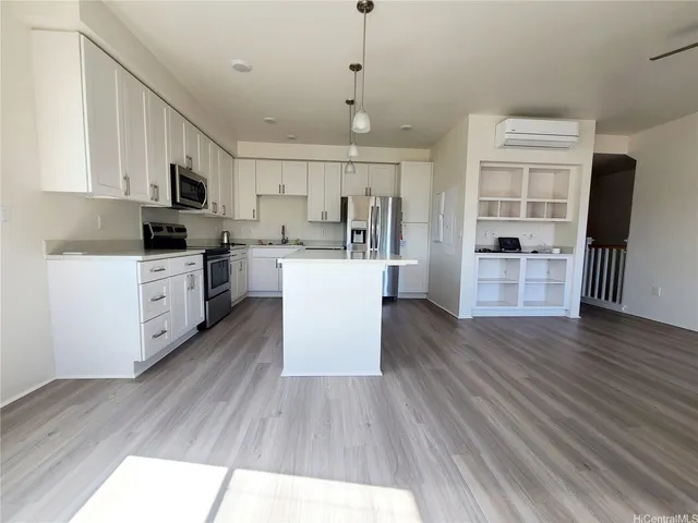 a kitchen with wooden floors and wooden cabinets