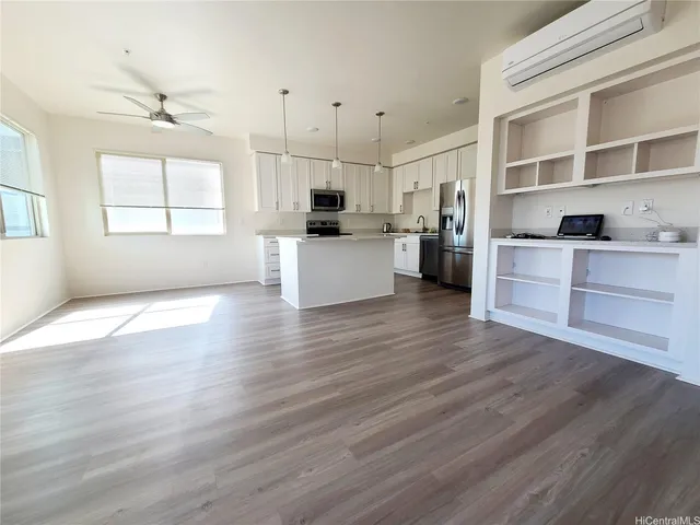 a kitchen with stainless steel appliances wooden floor and large window