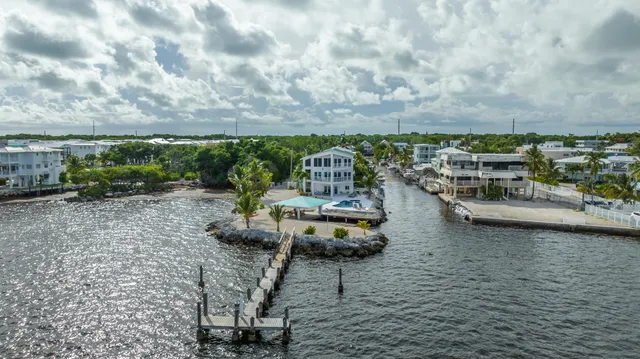 a view of a house with swimming pool and a yard