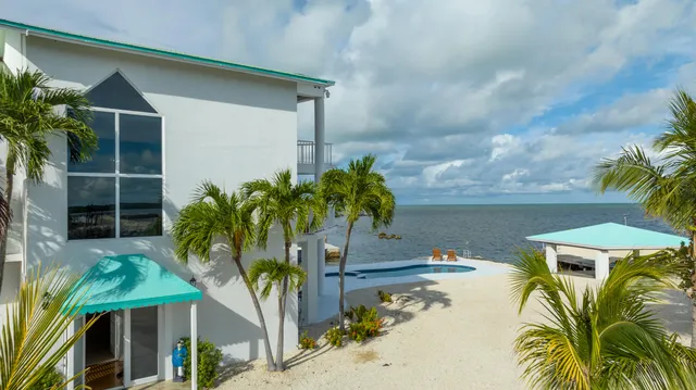 a kitchen with granite countertop a refrigerator and a stove top oven