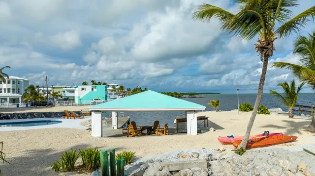 a living room with furniture a flat screen tv and a large window