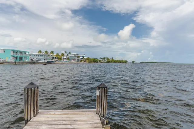 a dining room with furniture a chandelier and wooden floor