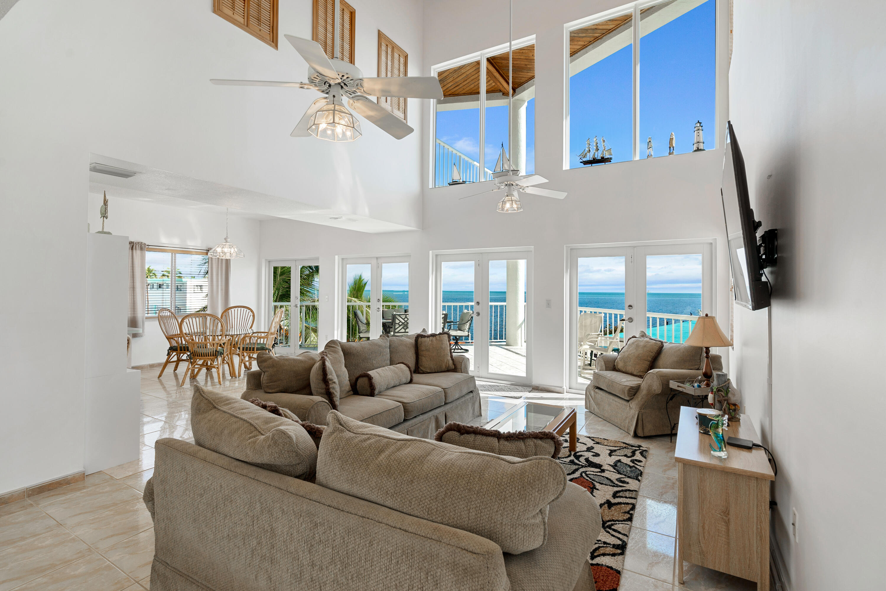 601 Cuda Lane Key Largo, FL 33037 - Photo 57 of 90 a living room with furniture a flat screen tv and a large window
