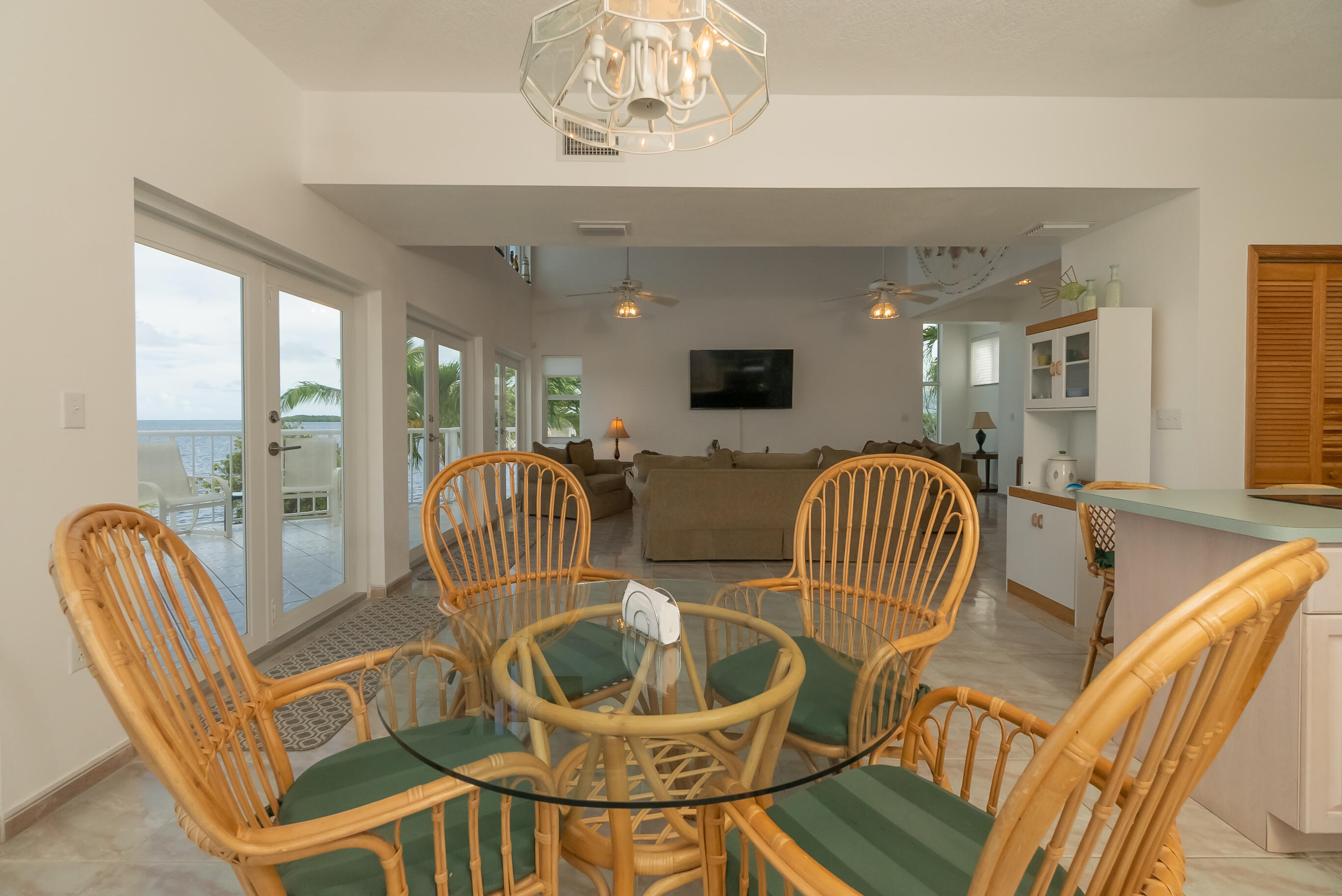601 Cuda Lane Key Largo, FL 33037 - Photo 61 of 90 a dining room with furniture a chandelier and wooden floor