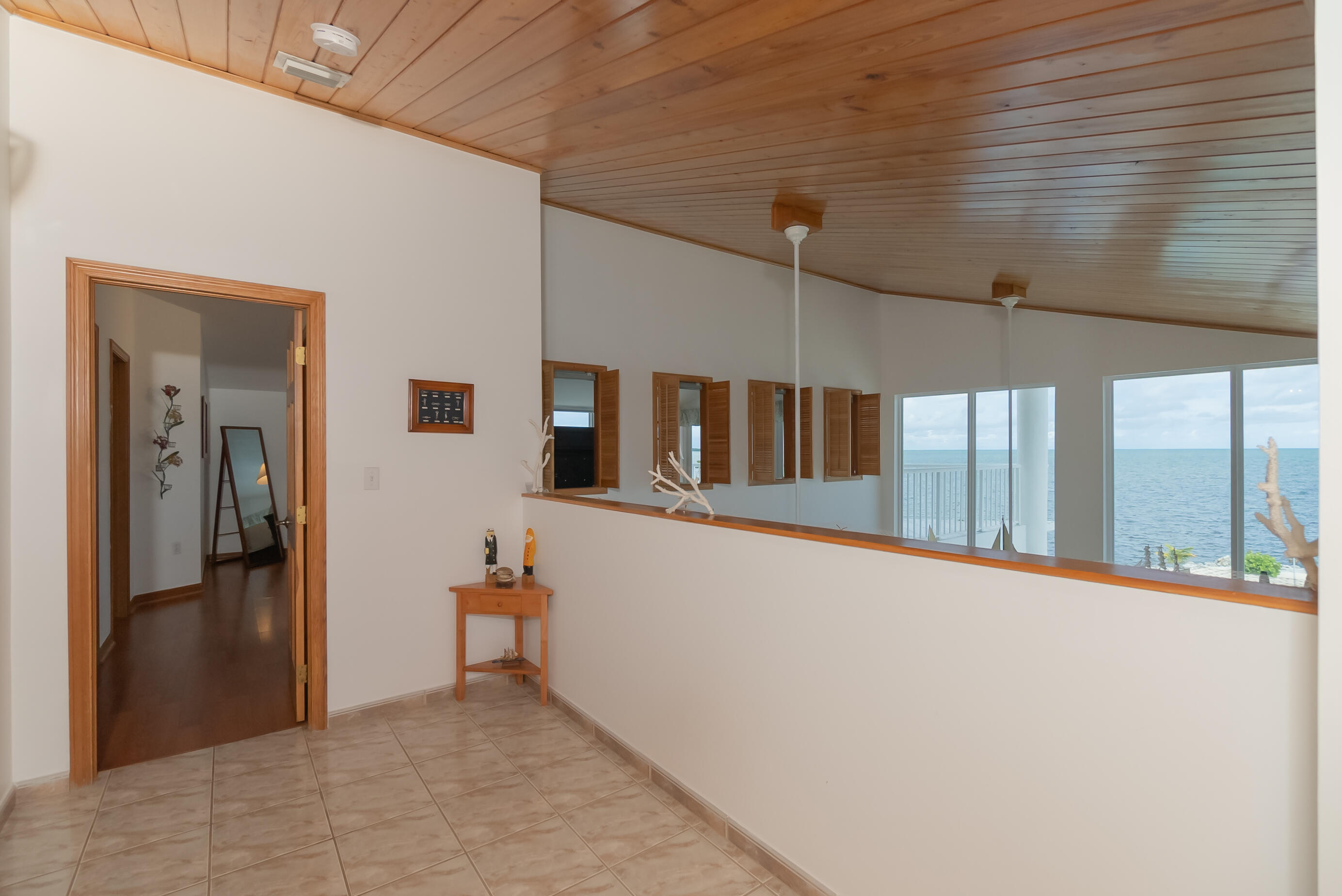 601 Cuda Lane Key Largo, FL 33037 - Photo 76 of 90 a view of a hallway with wooden floor and staircase