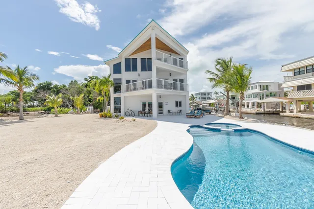 a view of a patio with table and chairs