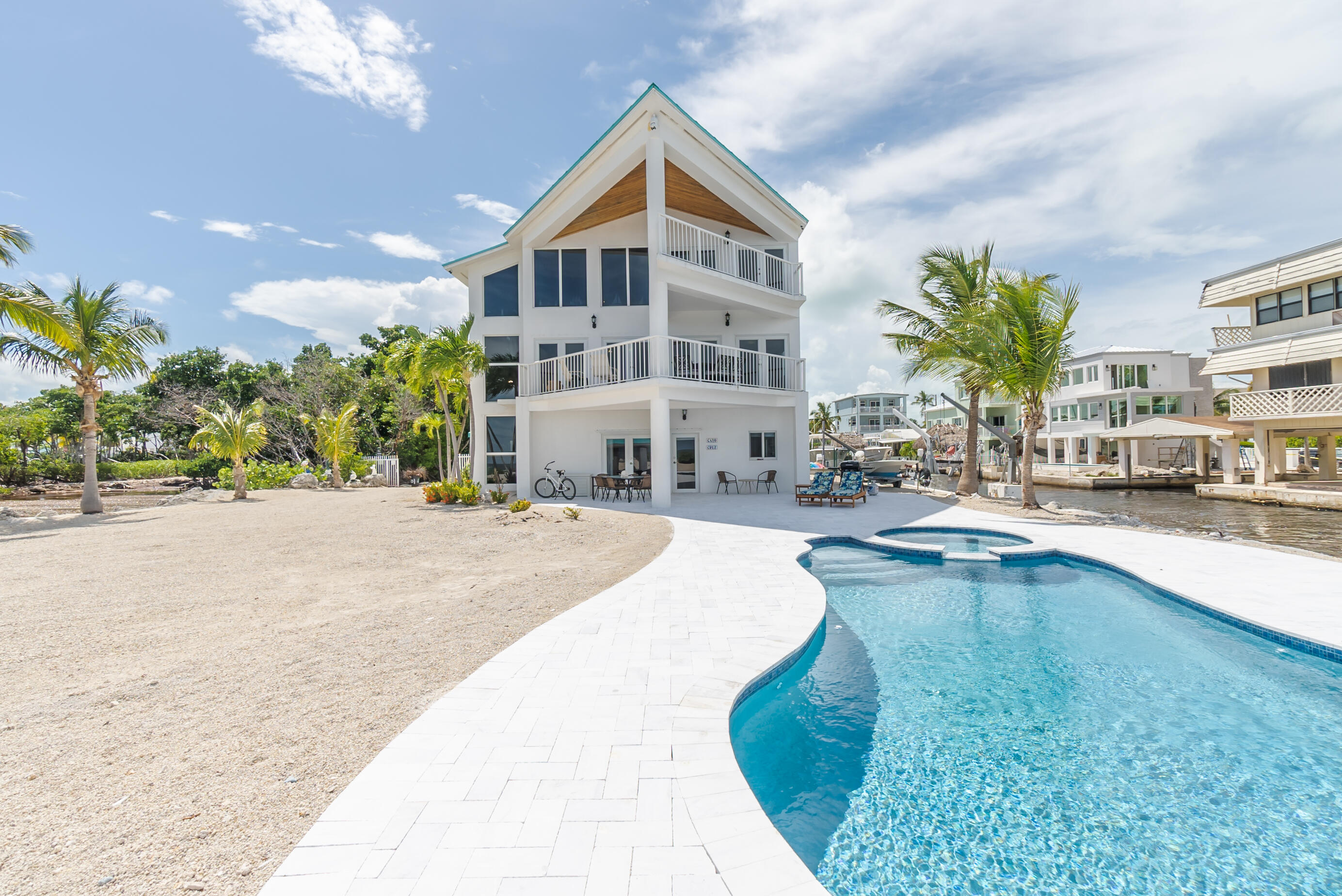 601 Cuda Lane Key Largo, FL 33037 - Photo 9 of 90 a swimming pool with outdoor seating and yard