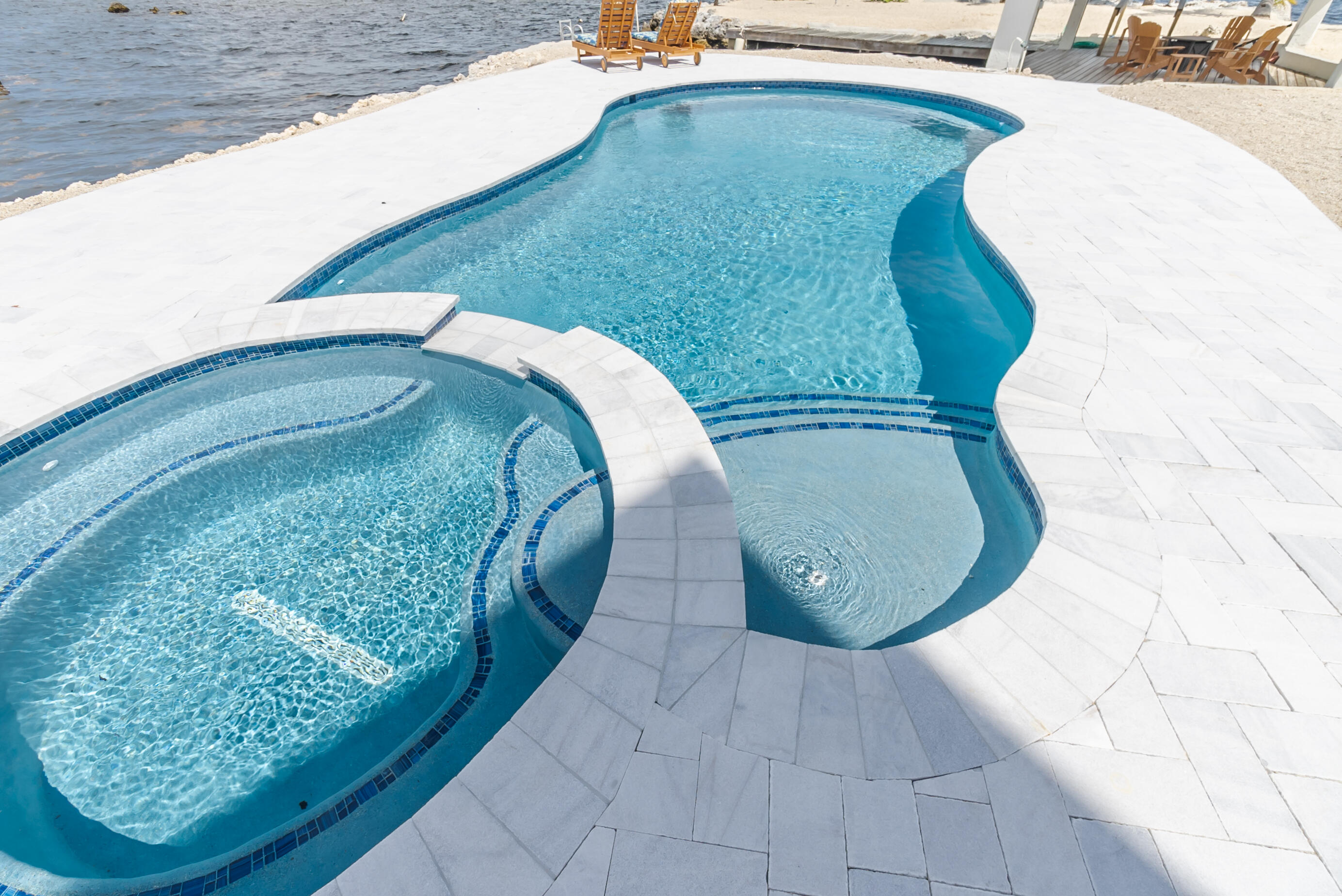601 Cuda Lane Key Largo, FL 33037 - Photo 10 of 90 a view of a swimming pool with a wooden floor