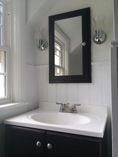 4843 Baptist Road Whitehall, PA 15227 - Photo 8 of 16 Full Bath. Light boarding accents the dark wood of the vanity.